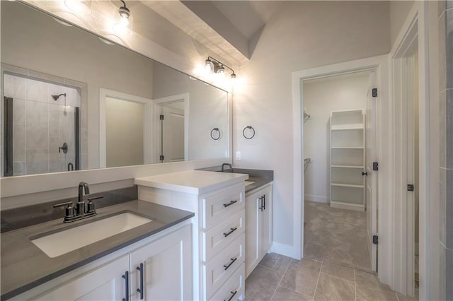 bathroom featuring lofted ceiling, a stall shower, a walk in closet, and vanity