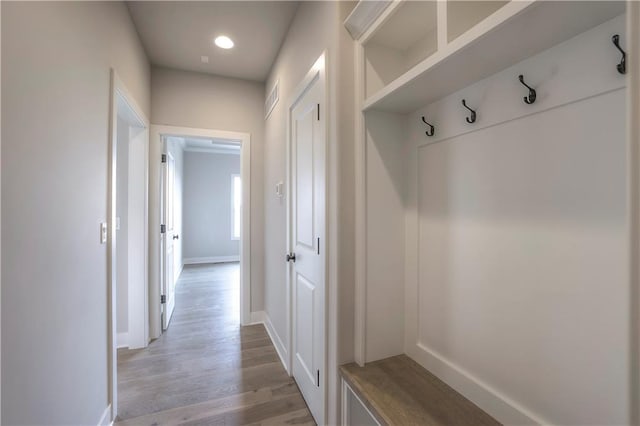 mudroom with light wood-style flooring, visible vents, and baseboards