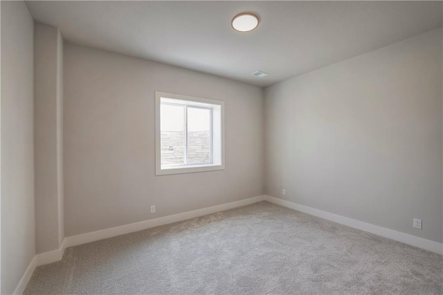 carpeted empty room with baseboards