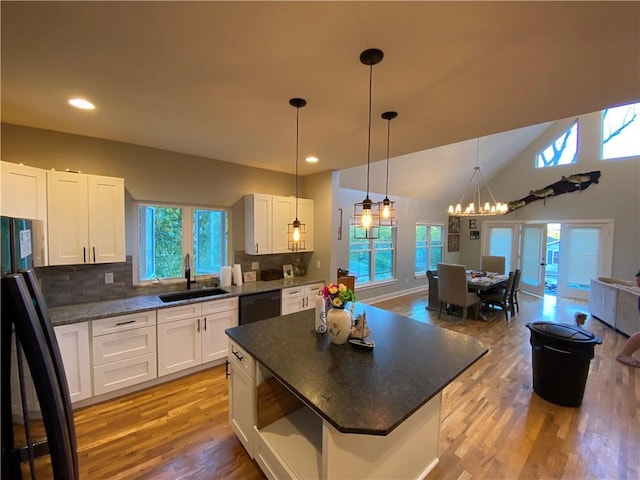 kitchen with plenty of natural light, sink, white cabinets, and black appliances