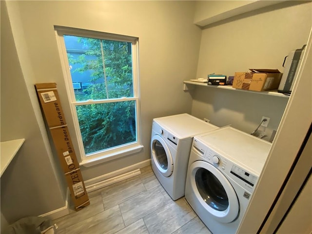 laundry area with a wealth of natural light and washing machine and clothes dryer