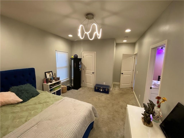 bedroom with an inviting chandelier and light colored carpet