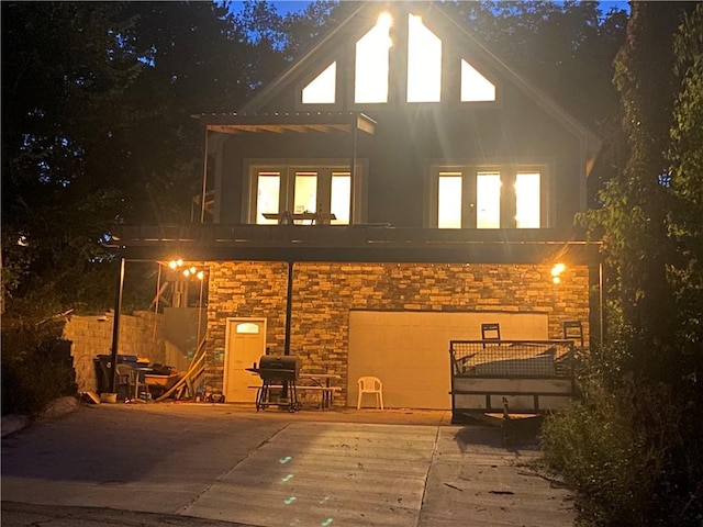 view of back house at twilight