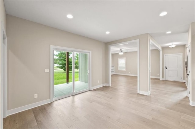 unfurnished living room with ceiling fan and light hardwood / wood-style floors