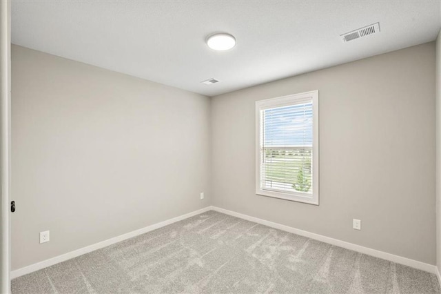 unfurnished room featuring light colored carpet