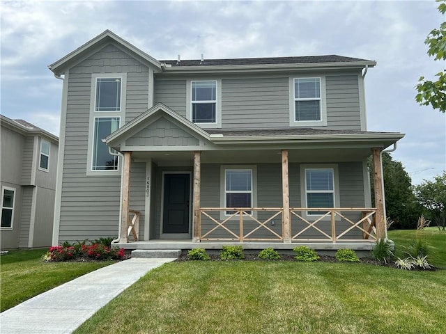 view of front of home featuring a front yard and covered porch