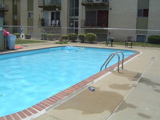 community pool featuring fence