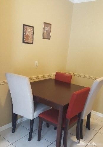 dining room featuring light tile patterned floors and baseboards