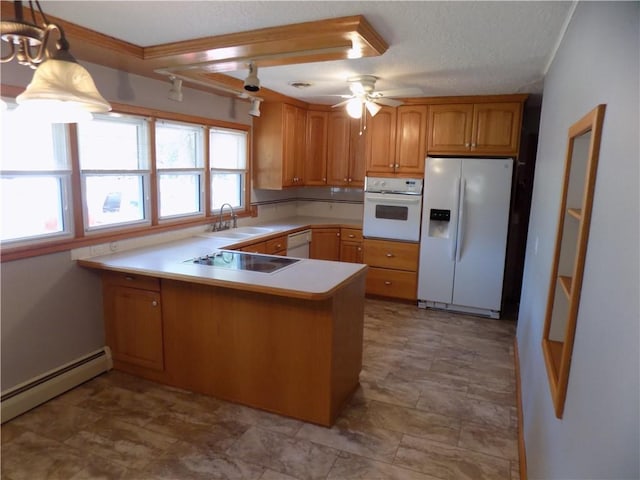 kitchen with ceiling fan, baseboard heating, a peninsula, white appliances, and a sink