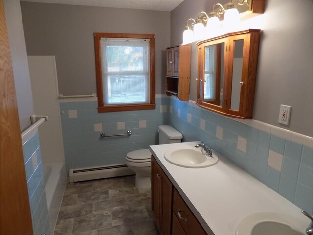 full bathroom with plus walk in shower, tile walls, a baseboard radiator, vanity, and toilet