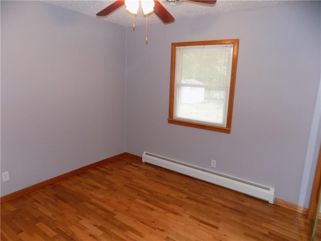 unfurnished room with light wood finished floors, a textured ceiling, a ceiling fan, and a baseboard radiator