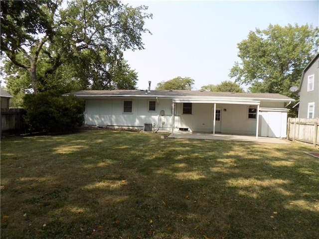 back of house featuring a lawn, a patio, and central air condition unit