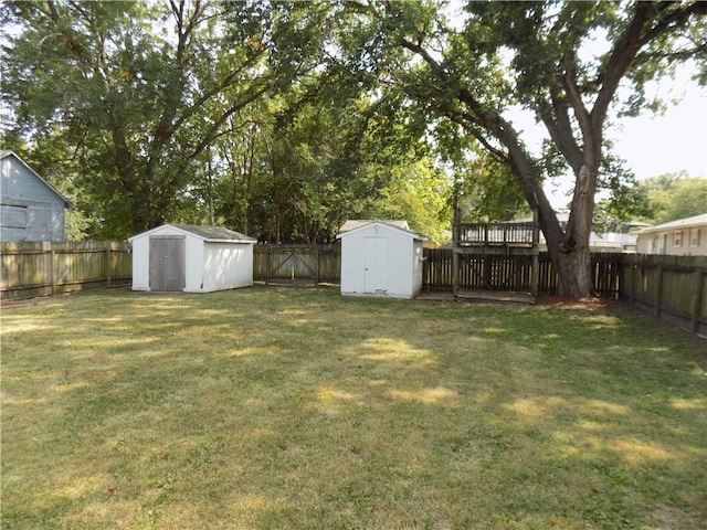 view of yard with a shed, an outdoor structure, and a fenced backyard