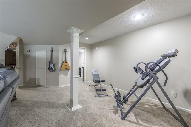 exercise area featuring a textured ceiling and carpet