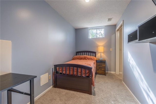 carpeted bedroom with a textured ceiling