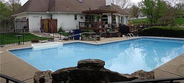 view of swimming pool with a patio