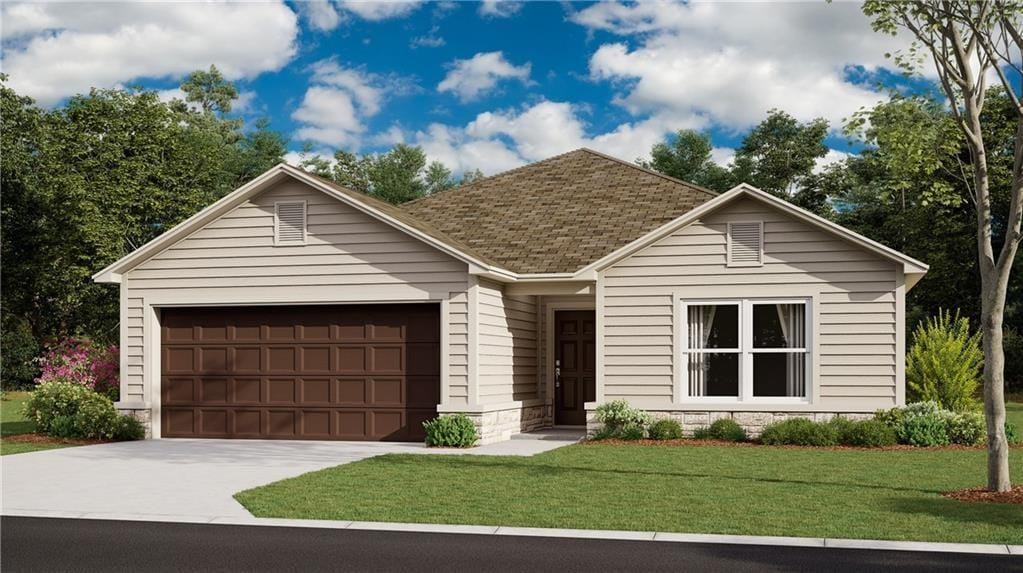 view of front of home featuring a garage and a front yard