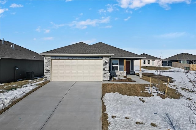 view of front of home featuring a garage, covered porch, and central air condition unit