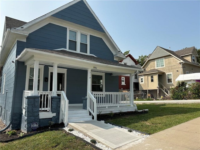 view of front facade with a front yard and a porch