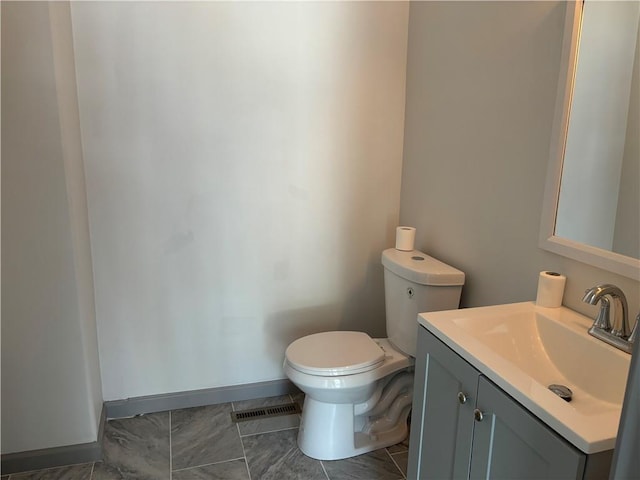 bathroom featuring toilet and vanity