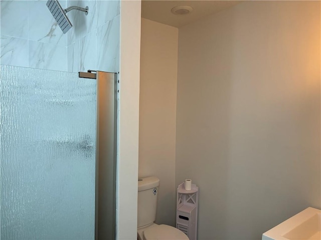 bathroom with a shower and toilet