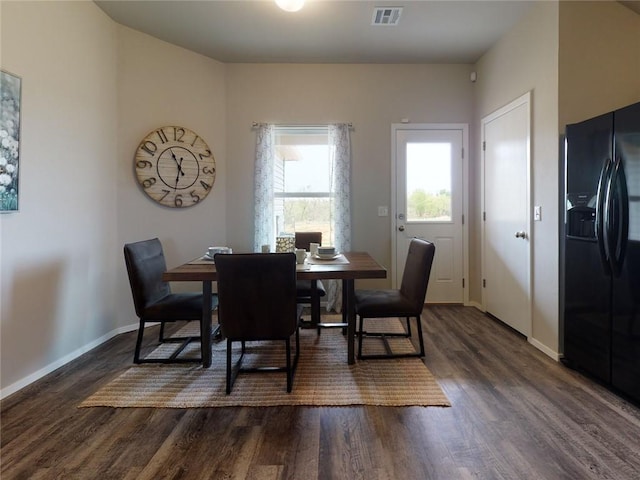 dining area featuring dark wood-type flooring