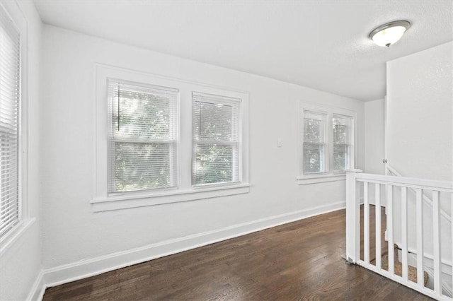 spare room with dark wood-type flooring