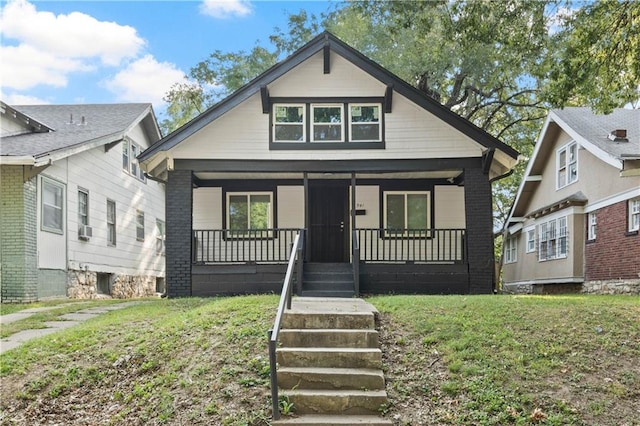 bungalow-style home with a porch and a front lawn