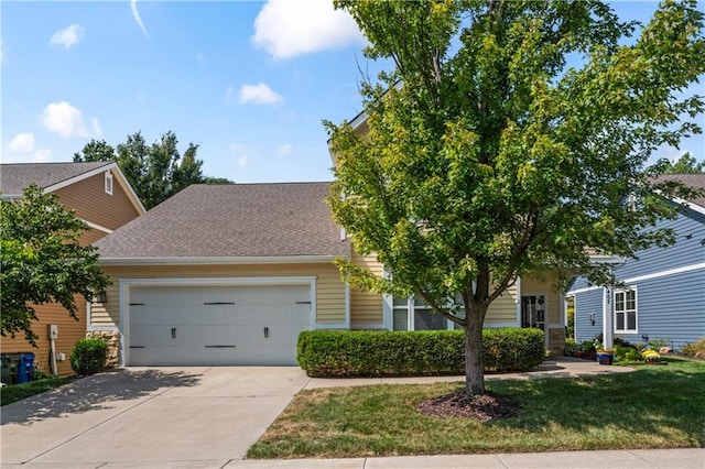 obstructed view of property featuring a garage and a front yard