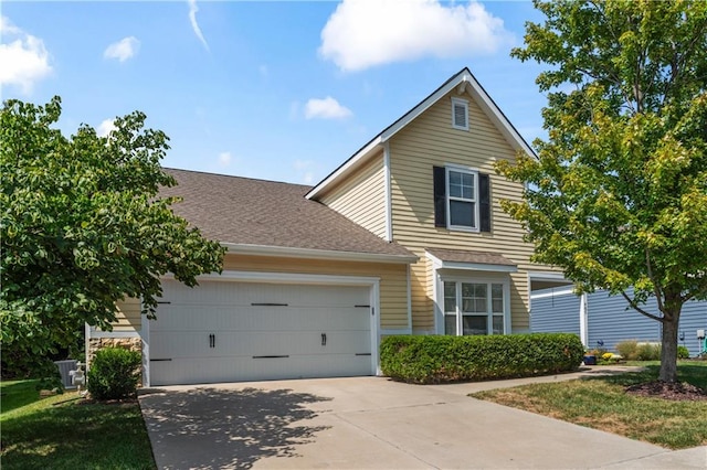 front of property with a garage and central AC