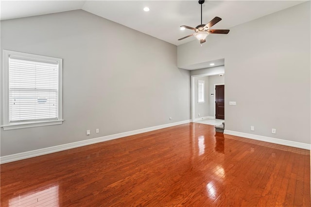 spare room with vaulted ceiling, wood-type flooring, and ceiling fan