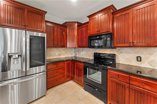 kitchen featuring dark stone countertops, black appliances, backsplash, and light tile patterned floors