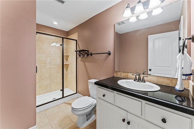 bathroom featuring vanity, toilet, a shower with shower door, and tile patterned flooring