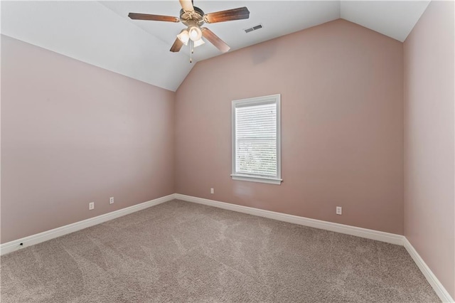 spare room featuring lofted ceiling, ceiling fan, and carpet floors