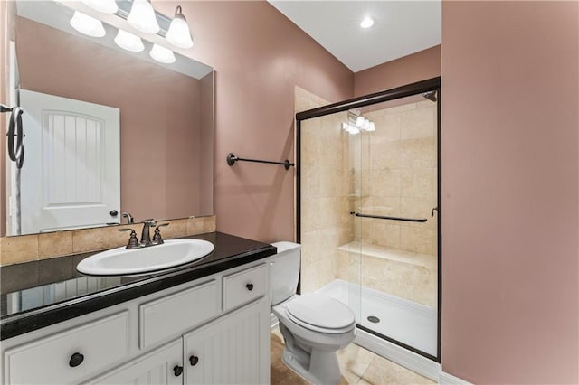 bathroom with vanity, toilet, walk in shower, and tile patterned floors