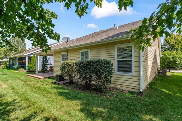 view of property exterior featuring a patio area, a lawn, and central AC unit