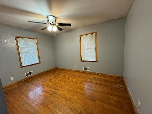 empty room with light wood-type flooring and ceiling fan