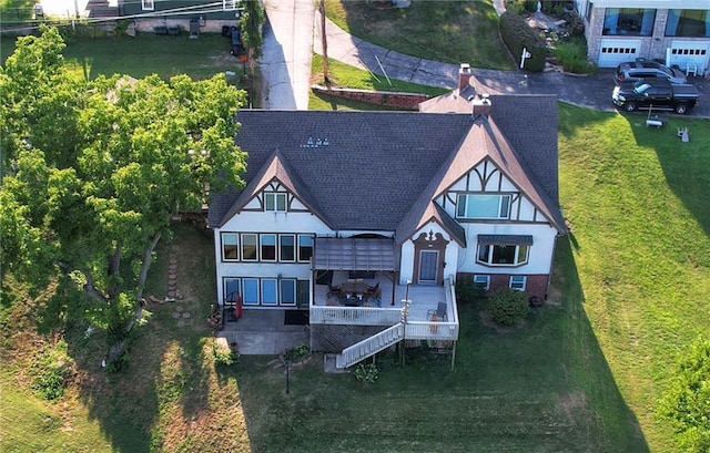 rear view of house featuring a yard