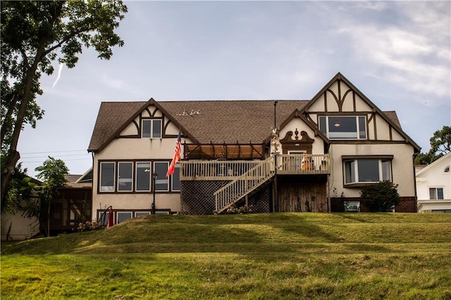 rear view of property with a lawn and a wooden deck