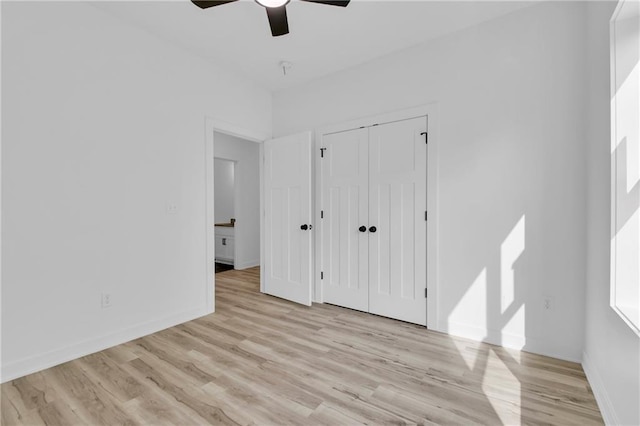 unfurnished bedroom featuring a closet, ceiling fan, and light hardwood / wood-style flooring