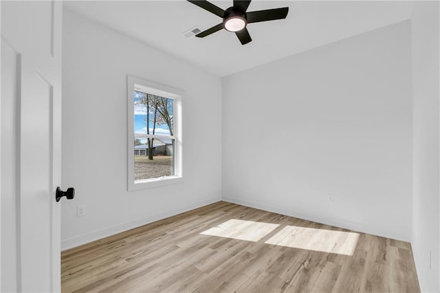 spare room featuring light hardwood / wood-style flooring and ceiling fan