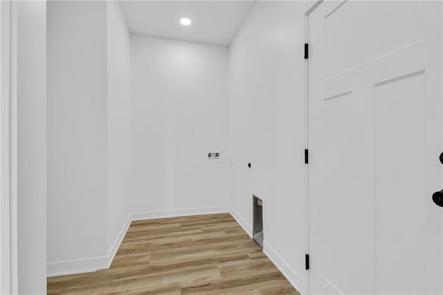 clothes washing area featuring light hardwood / wood-style floors, hookup for an electric dryer, and washer hookup