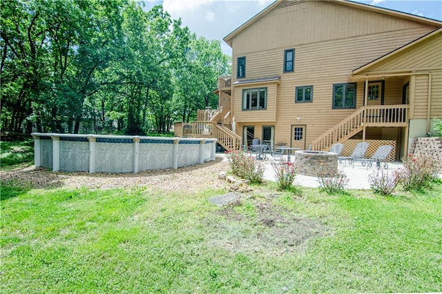 view of yard with a patio area and an outdoor fire pit