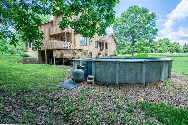 view of pool with a deck and a yard