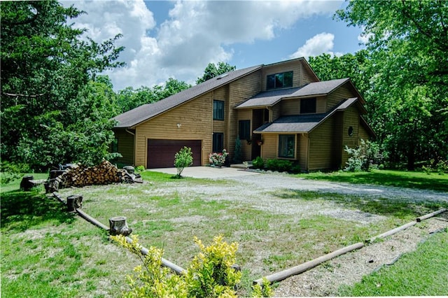 view of front of property featuring a garage and a front yard