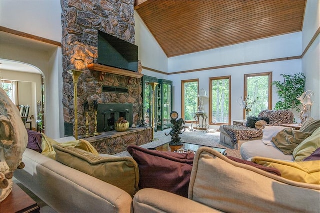 living room with high vaulted ceiling, carpet floors, a stone fireplace, and wood ceiling