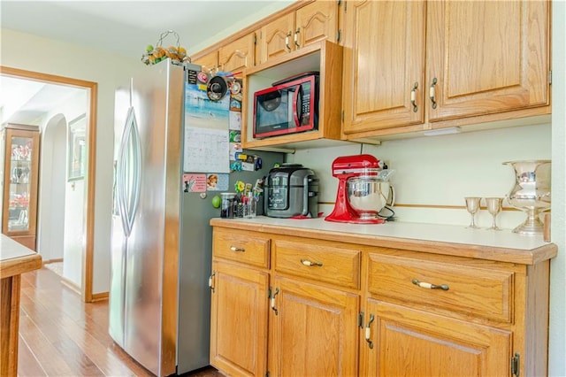 kitchen featuring light hardwood / wood-style flooring and stainless steel refrigerator with ice dispenser