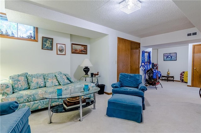 carpeted living room featuring a textured ceiling