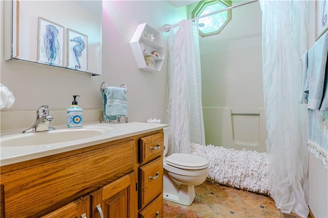 full bathroom with toilet, vanity, and shower / bath combination with curtain