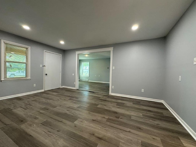 unfurnished room featuring dark wood-type flooring